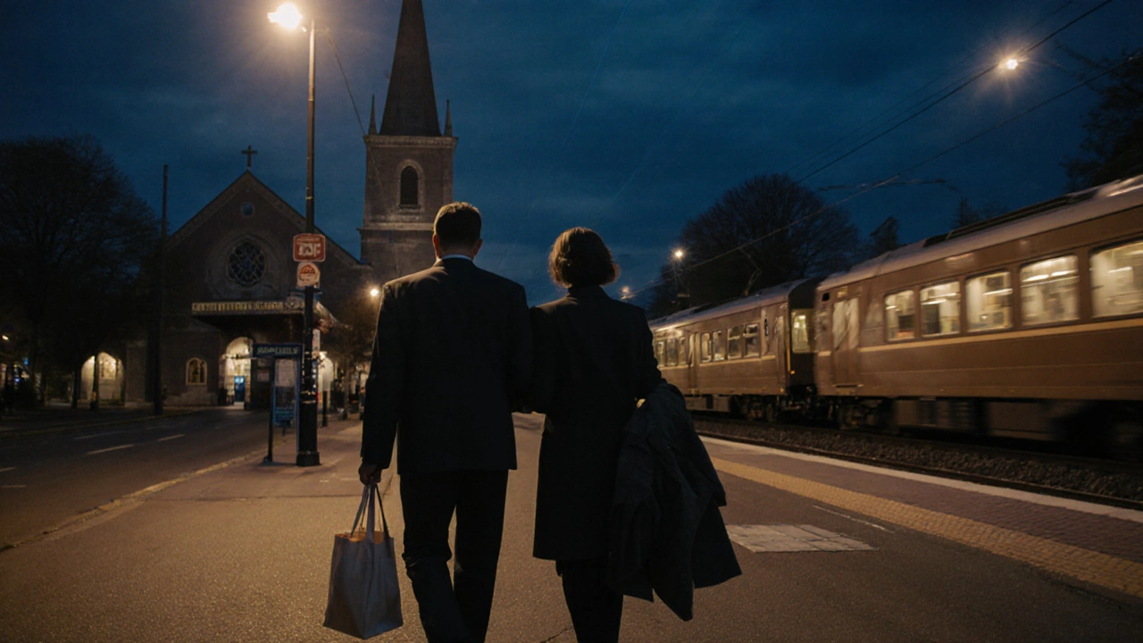 A man and woman walking together near Charlton train station at night.
