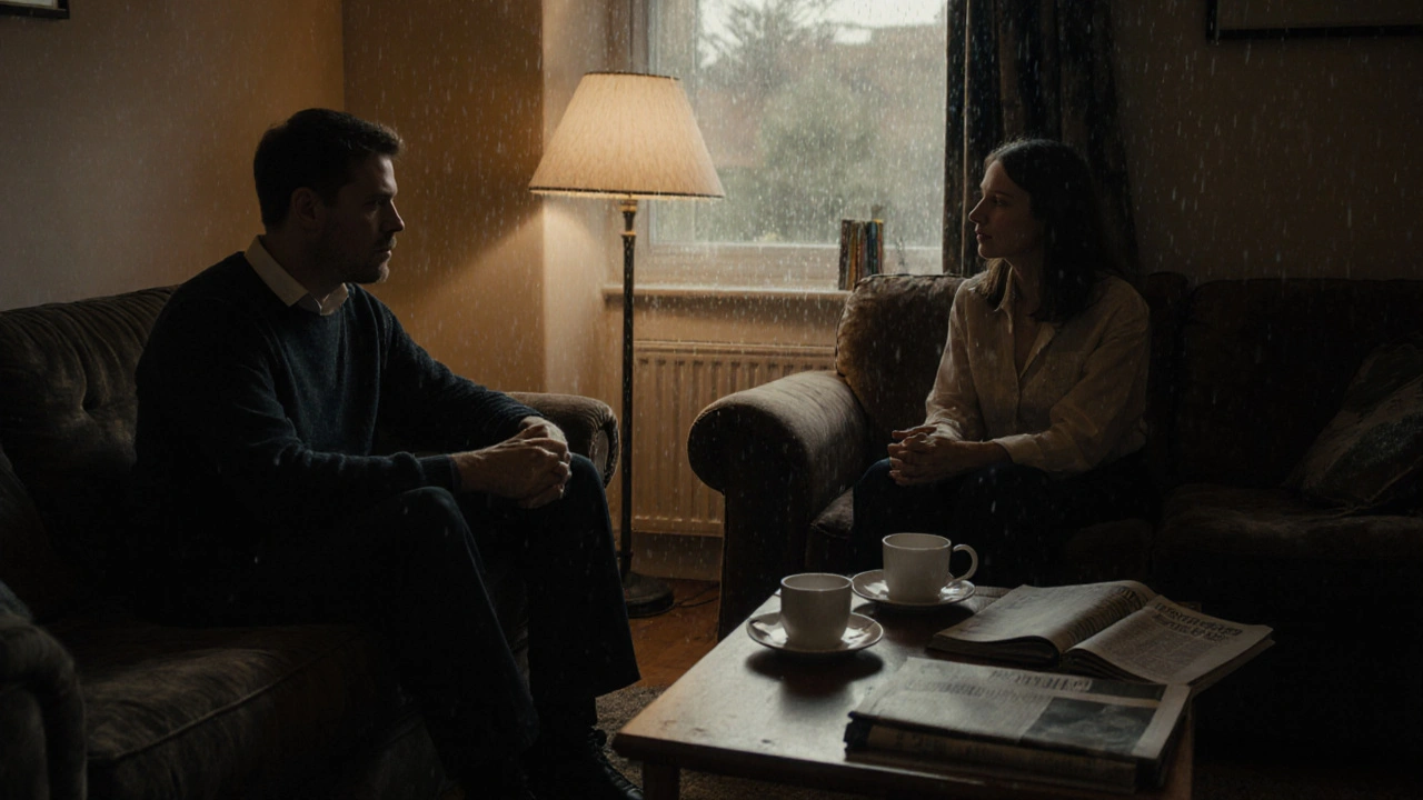 Two people sitting quietly together in a cozy living room, sharing tea and conversation under soft lamplight.